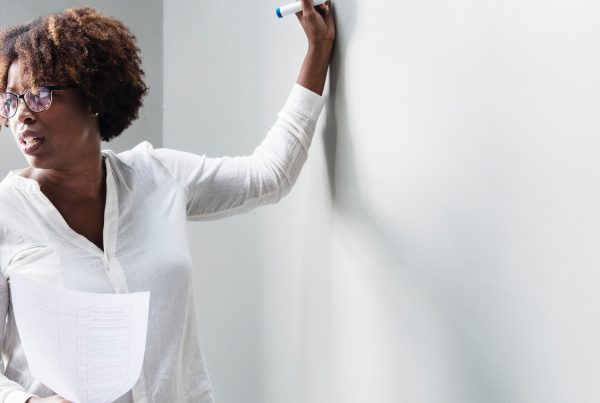 Woman writing on whiteboard