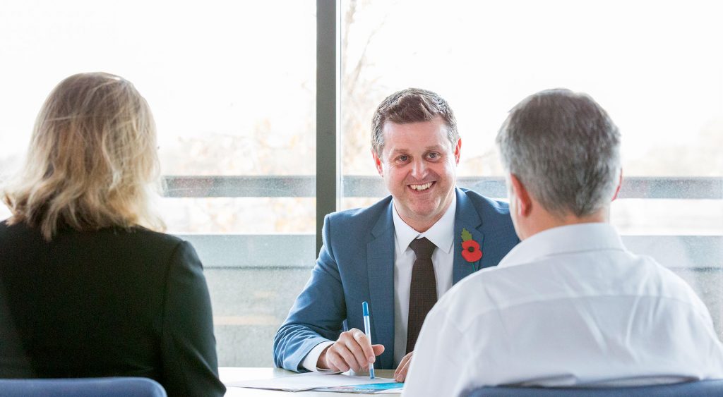 Jonathan smiling behind desk