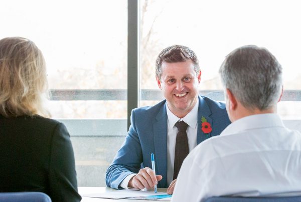 Jonathan smiling behind desk