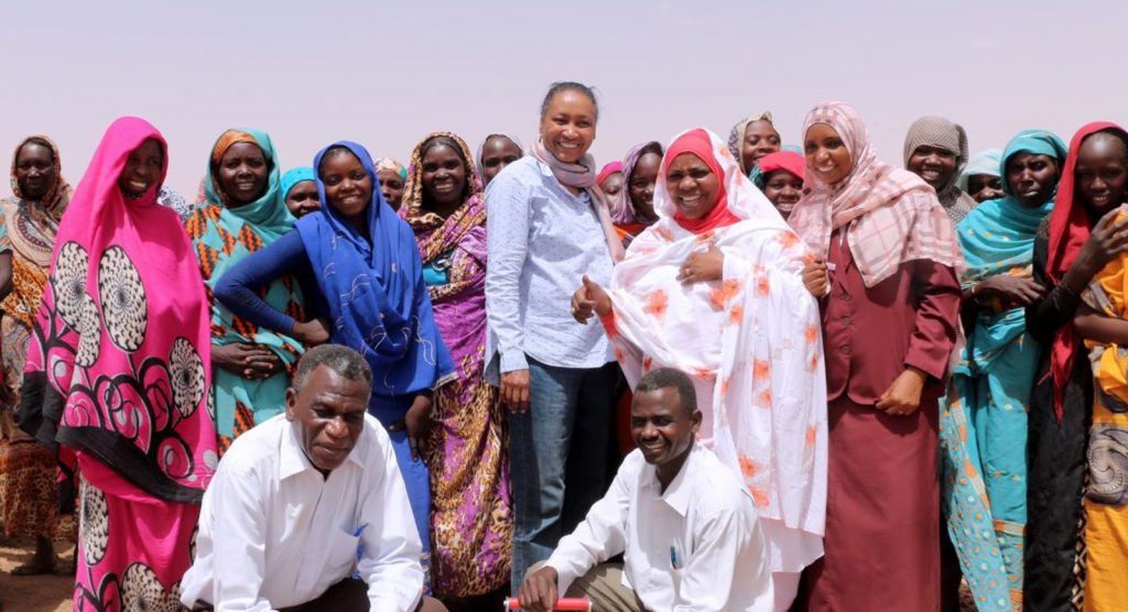 Muna among group of smiling locals