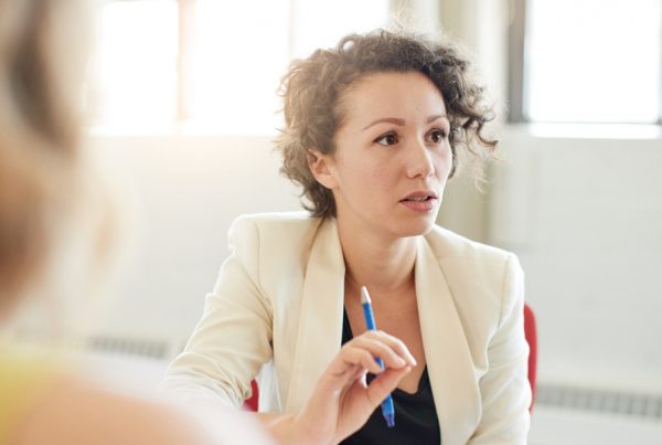 Young woman making point in meeting
