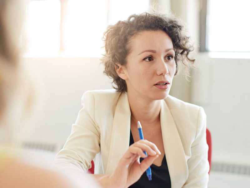 Young woman making point in meeting