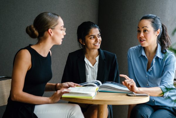Three women sat at table chatting