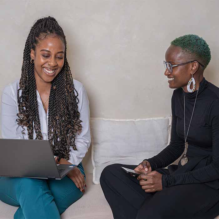 Evah and Blaise, from the Oxford HR team, working at a desk