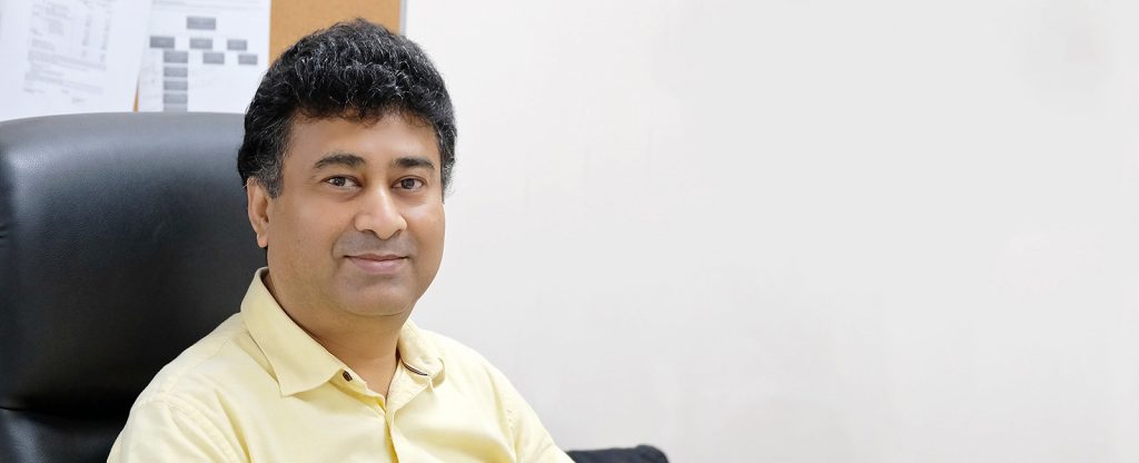 Angshu sat at his desk