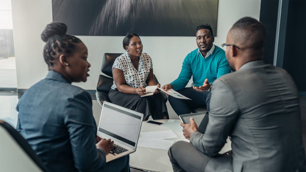 Group of people sat in meeting discussing work