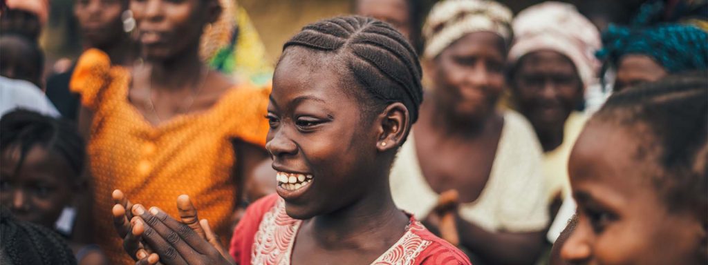 Sierra Leonian women looking at the ground and smiling