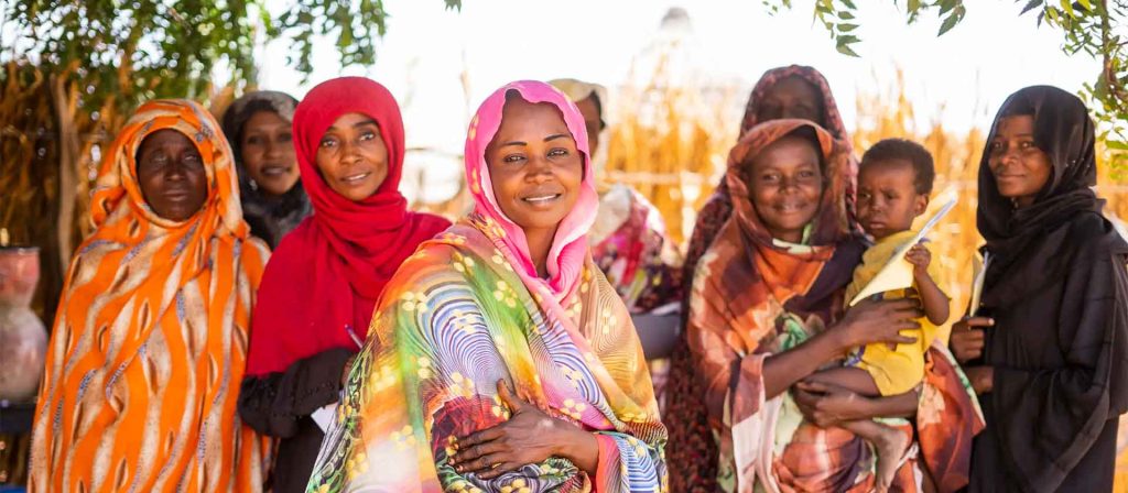 CARE Sudan staff smiling and posing wearing headscarves