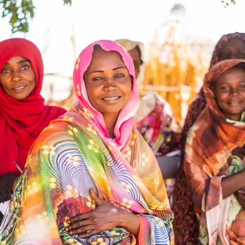 CARE Sudan staff smiling and posing wearing headscarves