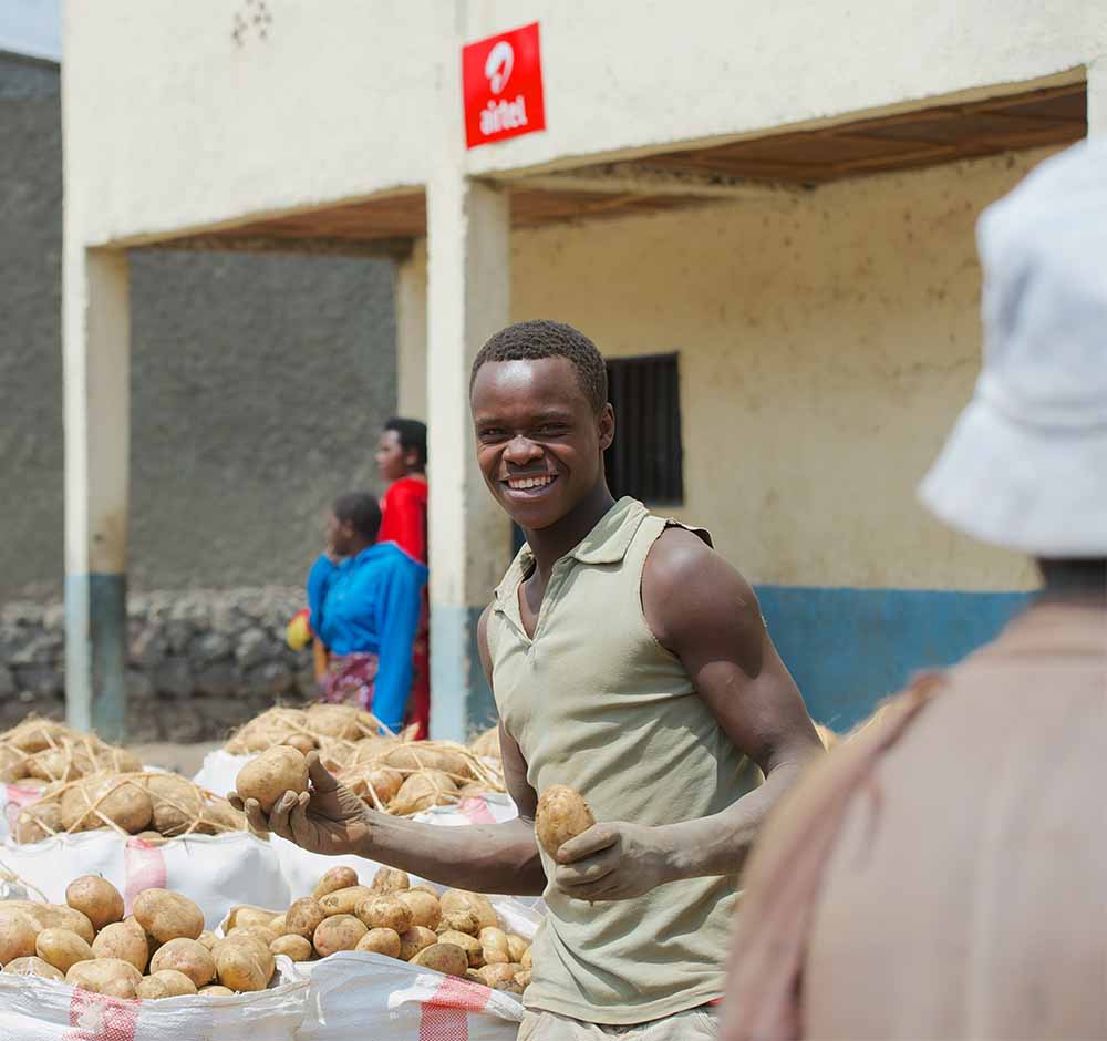 Smiling street vendor selling potatoes