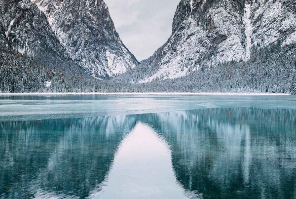 Wintry mountain range reflected in river