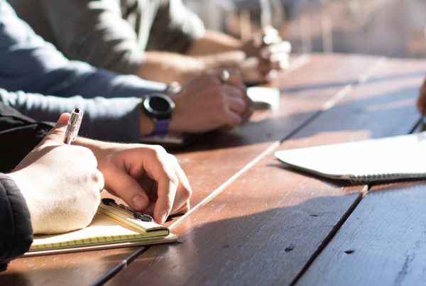 Group of people sitting around a desk planning