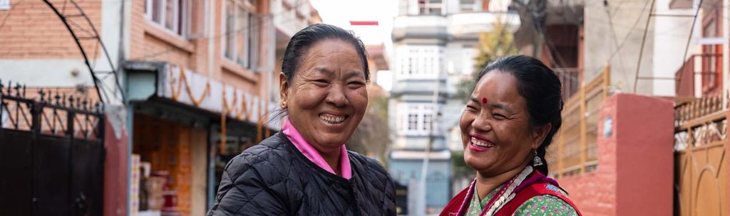Two women smiling in conversation