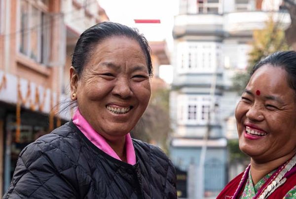 Two women smiling in conversation