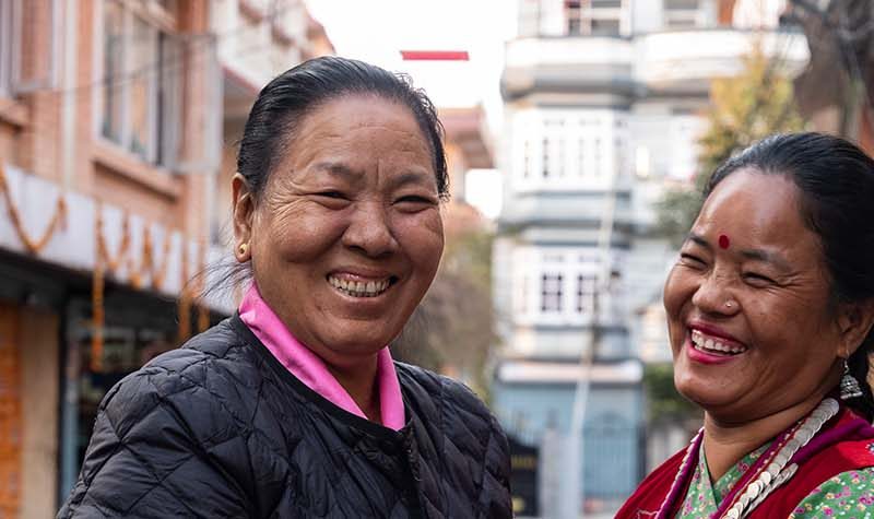 Two women smiling in conversation
