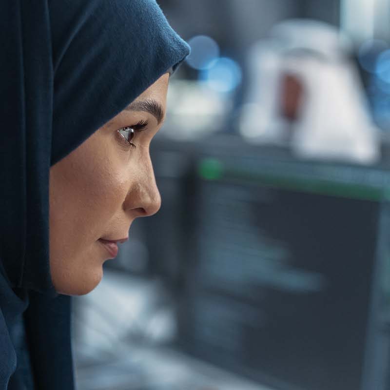 Woman examining information on a monitor