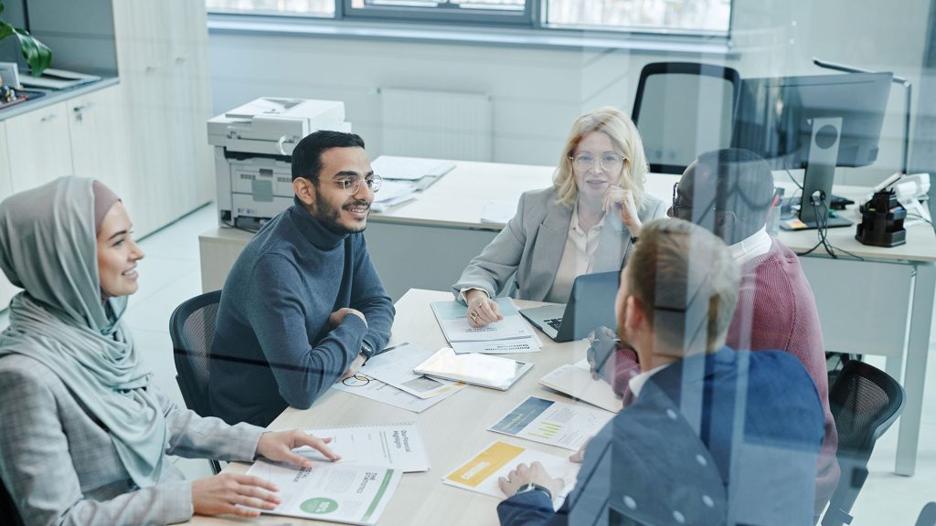 A diverse group of professionals engaged in a meeting at a modern office