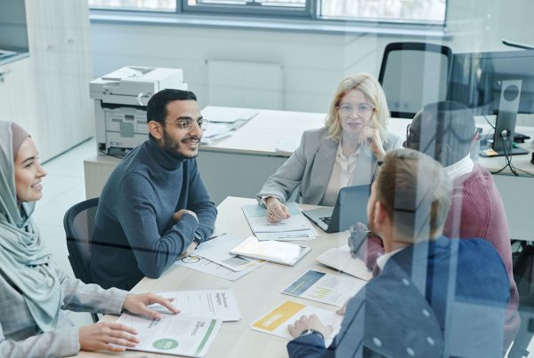 A diverse group of professionals engaged in a meeting at a modern office